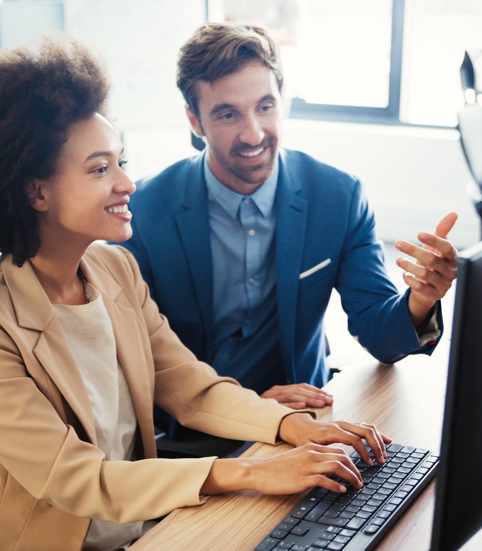 Two professionals working together at a computer